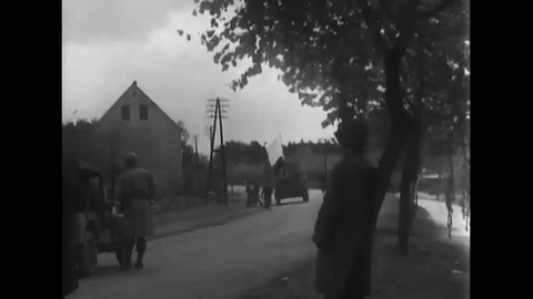 CIRCA 1945 - White flags and loudspeakers are mounted on US Army tanks in a German town, and Colonel Biddle meets with Russian soldiers.