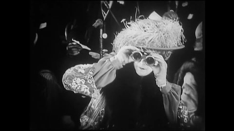 CIRCA 1925 - In this silent film, high society spectators at a racetrack gossip about a woman's graying hair.