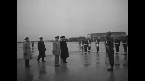 CIRCA 1951 - General Eisenhower inspects the Royal Grenadier Honor Guard with Vice Admiral van Holthe at the Amsterdam Airport.