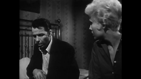 CIRCA 1955 - A drug addict (Frank Sinatra) warns his girlfriend (Kim Novak) what his withdrawal symptoms will be like while he's trying to quit.