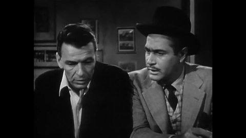 CIRCA 1955 - In this drama film, a drug dealer zeroes in on an addict (Frank Sinatra) in a bar.