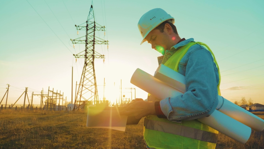 Industry energy business concept. Silhouette electrical engineer a working near tower with electricity at sunset time. Electrical worker inspect voltage electricity pylon. Power generation industry. Royalty-Free Stock Footage #1086021731