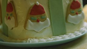 Christmas cake with gingerbread cookies in the shape of Santa Claus