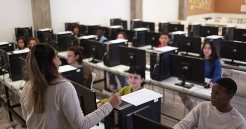 Young students using computers at school class