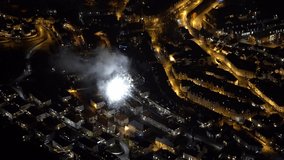 Fireworks in Sandviken Bergen city during new year celebration. Static clip looking down at rooftops and firework launched from the street