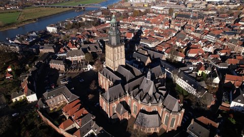 Walburgiskerk church in picturesque tower town of Zutphen in The Netherlands with river IJssel in the background. Aerial view of Dutch medieval city.