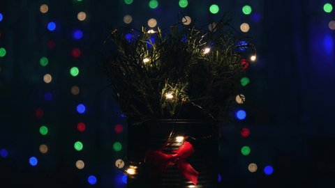 Christmas decorated eco christmas tree with bokeh lights on background in living room at night. Zero waste decorations. Loop video, Winter holiday atmosphere