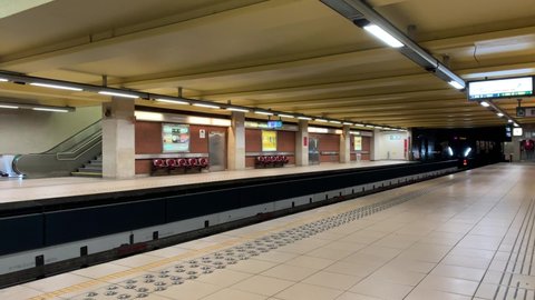 Brussels, Belgium - January 15, 2022: Brussels STIB-MIVB metro train arrives at Josephine Charlotte underground subway station. Empty platform. It is a station for number 1 (purple) line.