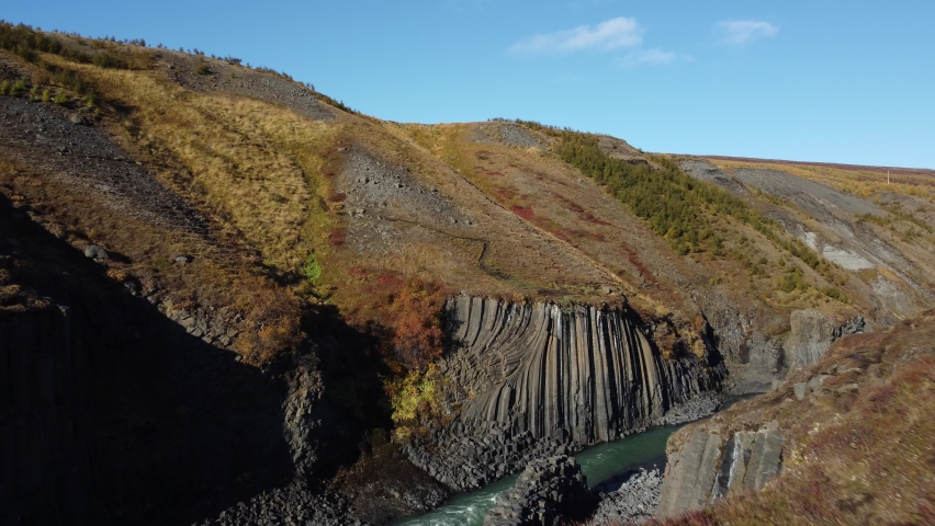 Approaching flight to basaltic river bank