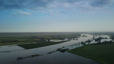 High water level on the floodplains of the river IJssel near the city of Zwolle in Overijssel during summer after heavy rainfall upstream. Aerial drone point of view.