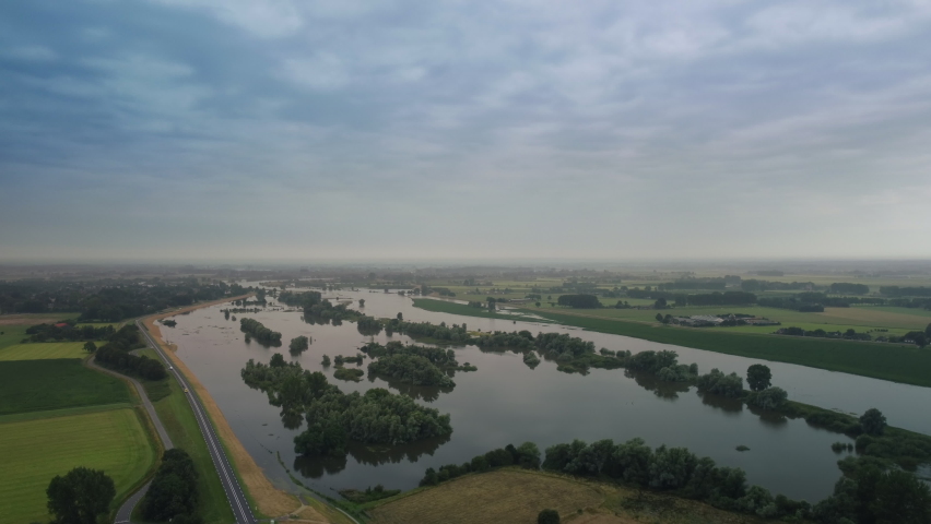 High water level on the floodplains of the river IJssel near the city of Zwolle in Overijssel during summer after heavy rainfall upstream. Aerial drone point of view.