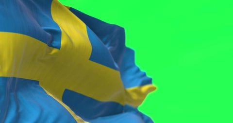 Detail of the national flag of Sweden waving in the wind isolated on green background. Democracy and politics. North European country. Selective focus. Seamless Slow motion. Chroma key