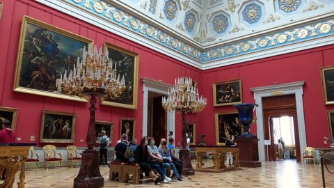 Saint Petersburg, Russia, May 11, 2021. Hermitage Museum interior. Visitors from different countries get acquainted with the paintings of famous artists and interiors of the tsarist times of Russia.
