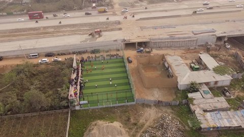Dhaka, Bangladesh-January 14,2022: Aerial view of a futsal stadium which is build beside developing highway.