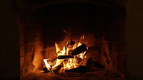 A Looping Clip of a Fireplace with Medium Size Flames Burning Fire. Warm Cozy Fireplace with Real Wood Burning in it Winter and Christmas Holidays Concept