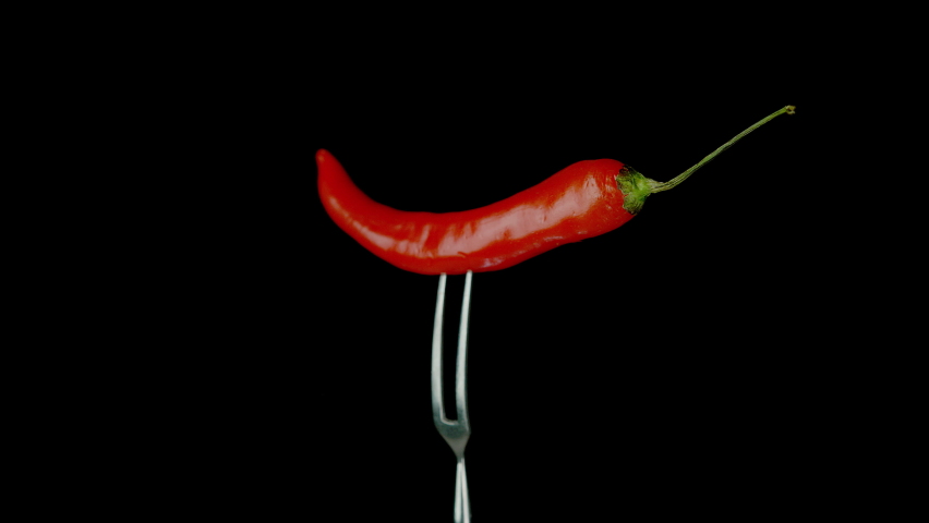 Chili Pepper on Fork Spinning in Exploding Flames in Slow Motion 1000fps on the Black Background Royalty-Free Stock Footage #1086052871