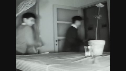 COMO, ITALY MAY 1960: Mother chases boys with broom in 60s