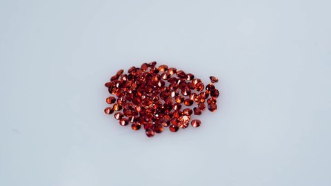 natural red round spessartins garnets gem stone on the white background