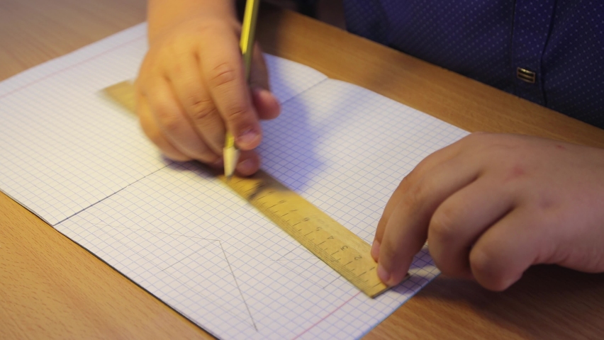 Close-up hands of a high school student draw a geometric shape. A schoolboy at the workplace does his job. Education concept, modern school, knowledge acquisition, traditional learning. UHD 4K. - Powered by Shutterstock - Get 15% off with code: PIKWIZARD15