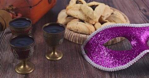 Purim Jewish holiday with hamantaschen cookies hamans ears, carnival mask, and parchment