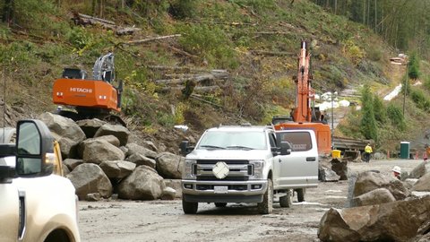 Popkum , British Columbia , Canada - 11 23 2021: Excavator Removing Debris Blocking The Highway Caused By A Landslide Near Popkum