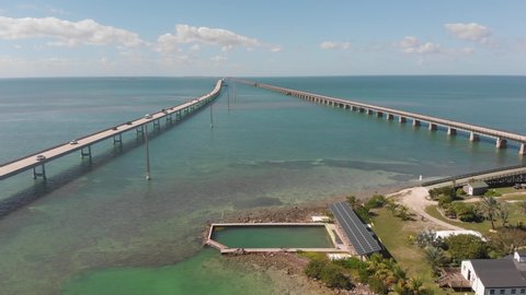 Marathon , FL , United States - 01 21 2022: seven mile bridge florida keys pigeon old new tropical vacation destination blue water gulf of mexico tourism aerial drone trucking.mp4
