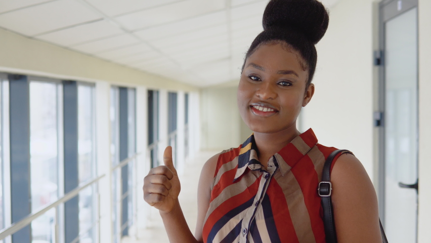 African american woman student with a books in the university. Education concept