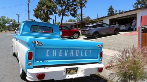 Yucaipa, California, April 17, 2021: A Restored Classic 1960s Chevy Pick Up Truck on the Street with a Profile Video