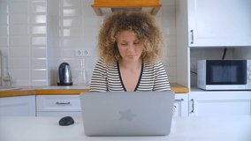Freelance woman working online at home. Beautiful young female doing distant work with modern laptop and fast internet connection. Freelancer person using notebook computer in 4k stock footage