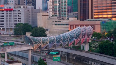 KUALA LUMPUR, MALAYSIA, 22 JAN 2022 : Timelapse of a beautiful colourful pedestrian bridge named Lintasan Saloma near to majestic Kuala Lumpur Petronas Twin Tower (KLCC).