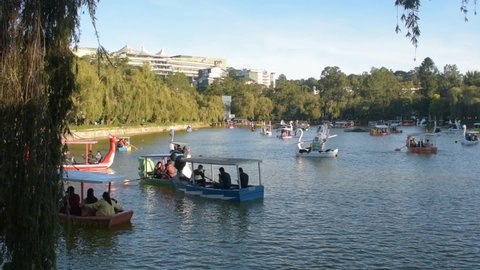 Baguio City, Philippines -  December 31, 2021: People enjoying boating at Burnham Lake at the popular Burnham park on the last day of 2021 less than 10 hours before New Year's eve.