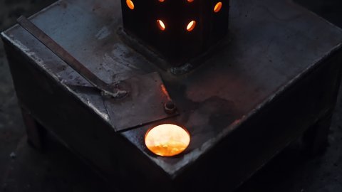 Oil burning in the furnace dark indoors closeup