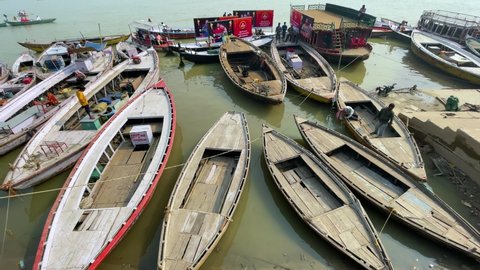 Ghats of the Ganges river with big, small running boats in Varanasi. Aerial view of Varanasi ghats: Varanasi, Uttar Pradesh, India - November 19 2021