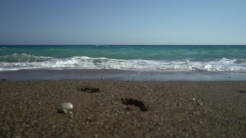 Beautiful sand beach with soft wave in sea water , blue sky sunny day