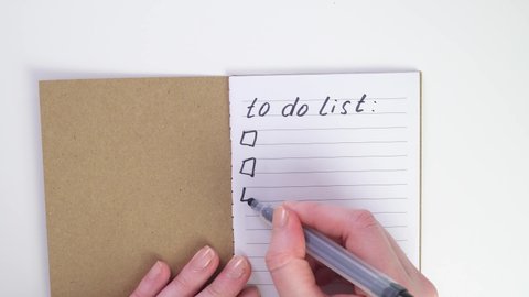 flat lay to do list write in notebook with black pen or felt-tip pen. Make to-do list on a sheet. Place for text. Top view of working white table. To do list in notebook with office suppliers on desk.