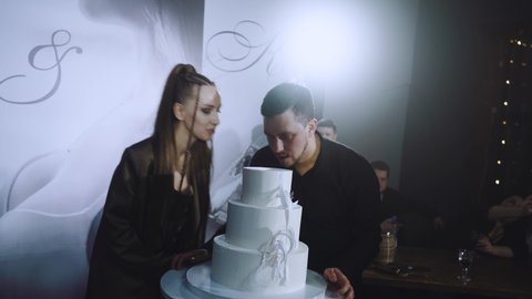 Nizhny Novgorod, January 23, 2022. Newlyweds bite the wedding cake at the wedding