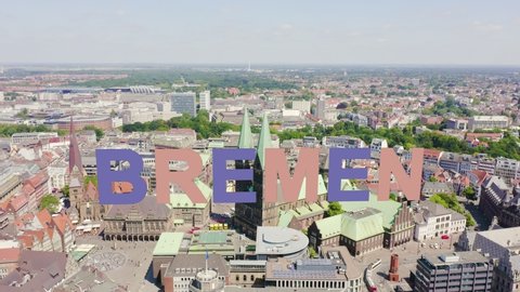 Inscription on video. Bremen, Germany. The historic part of Bremen, the old town. Bremen Cathedral ( St. Petri Dom Bremen ). View in flight. Multicolored text appears and disappears, Aerial View, Poi