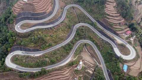 Timelapse aerial view of the traffic on the BP Highway, Bardibas Highway, as it winds through the rugged hills of Nepal.