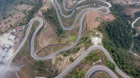 Straight down aerial view of traffic on the BP Highway, Bardibas Highway, showing the switchbacks and turns as it winds through the hills of Nepal.