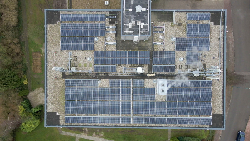 Top down view of solar panels on apartment building rooftop - drone setting down Royalty-Free Stock Footage #1086092150
