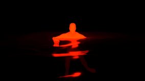 Black background with animation. Design. A black background on which the silhouette of a red person turns into a spot.