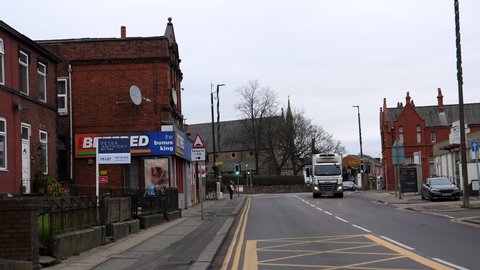 SALFORD, ENGLAND, UNITED KINGDOM - JANUARY, 2022: Driving Liverpool Road, typical main road in Eccles town in Greater Manchester in winter.