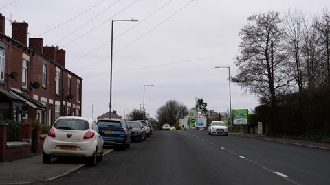 WESTHOUGHTON, GREATER MANCHESTER, ENGLAND, UNITED KINGDOM - JANUARY, 2022: Driving A6 Manchester Road past BP petrol station in Westhoughton town, Metropolitan Borough of Bolton.
