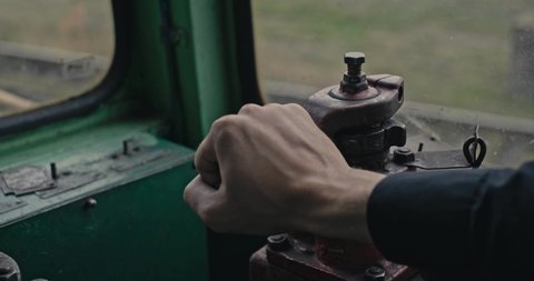 Cinematic shot: The driver switches gears in the old Czechoslovak locomotive of the ChMEZ of the USSR times