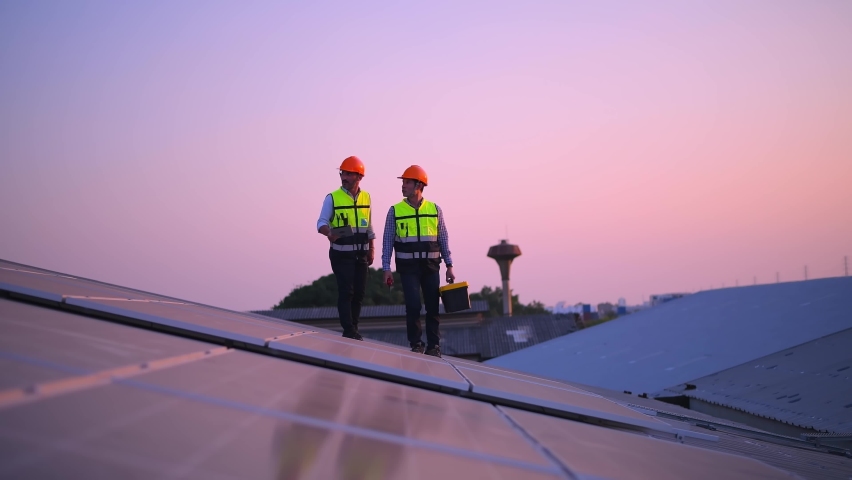 Video engineers ware uniform working on roof inspect and check solar cell panel equipment box ,drill and measuring cassette solar cell is smart grid ecology energy sunlight alternative power. Royalty-Free Stock Footage #1086103226