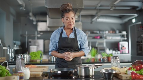 TV Cooking Show in Restaurant Kitchen: Portrait of Black Female Celebrity Chef Talks, Teaches Fun Way How to Cook Food. Online Video Courses, Learning Video Lectures. Healthy Dish Recipe Preparation