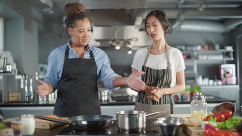 Celebrity TV Cooking Show Kitchen: Asian and Black Female Chefs Talk, Teach How to Cook Food. Online Video Courses, Television Program Presenters. Preparation of Healthy Traditional Fusion Dish Recipe