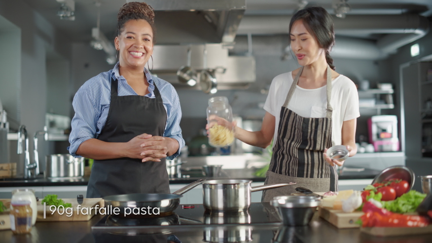 Part Two of TV Cooking Show Playback Montage in Restaurant Kitchen with Black and Asian Female Chefs. Presenter and Guest Talk, Have Fun, Show How to Cook Food. Step-by-Step Healthy Meal Preparation | Shutterstock HD Video #1086104699