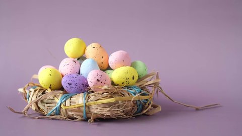 easter concept with multi color egg on purple background.