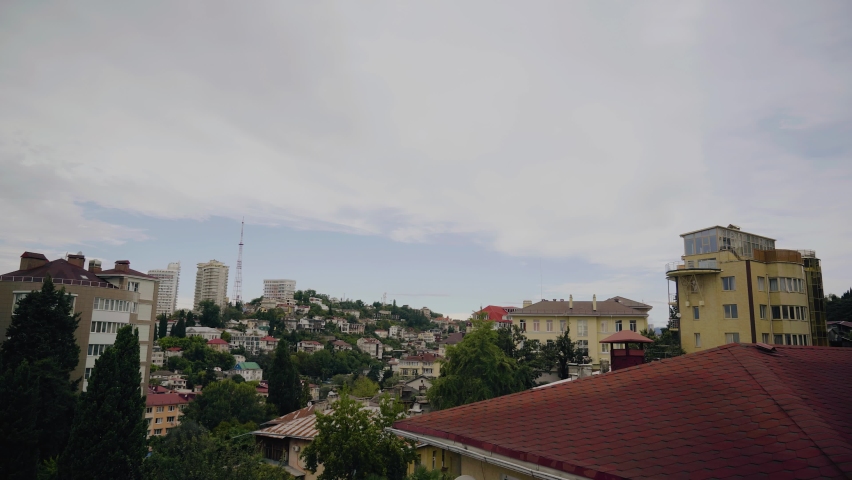 The city is located on the hills and clouds float over it and the weather changes. Shooting a timelapse